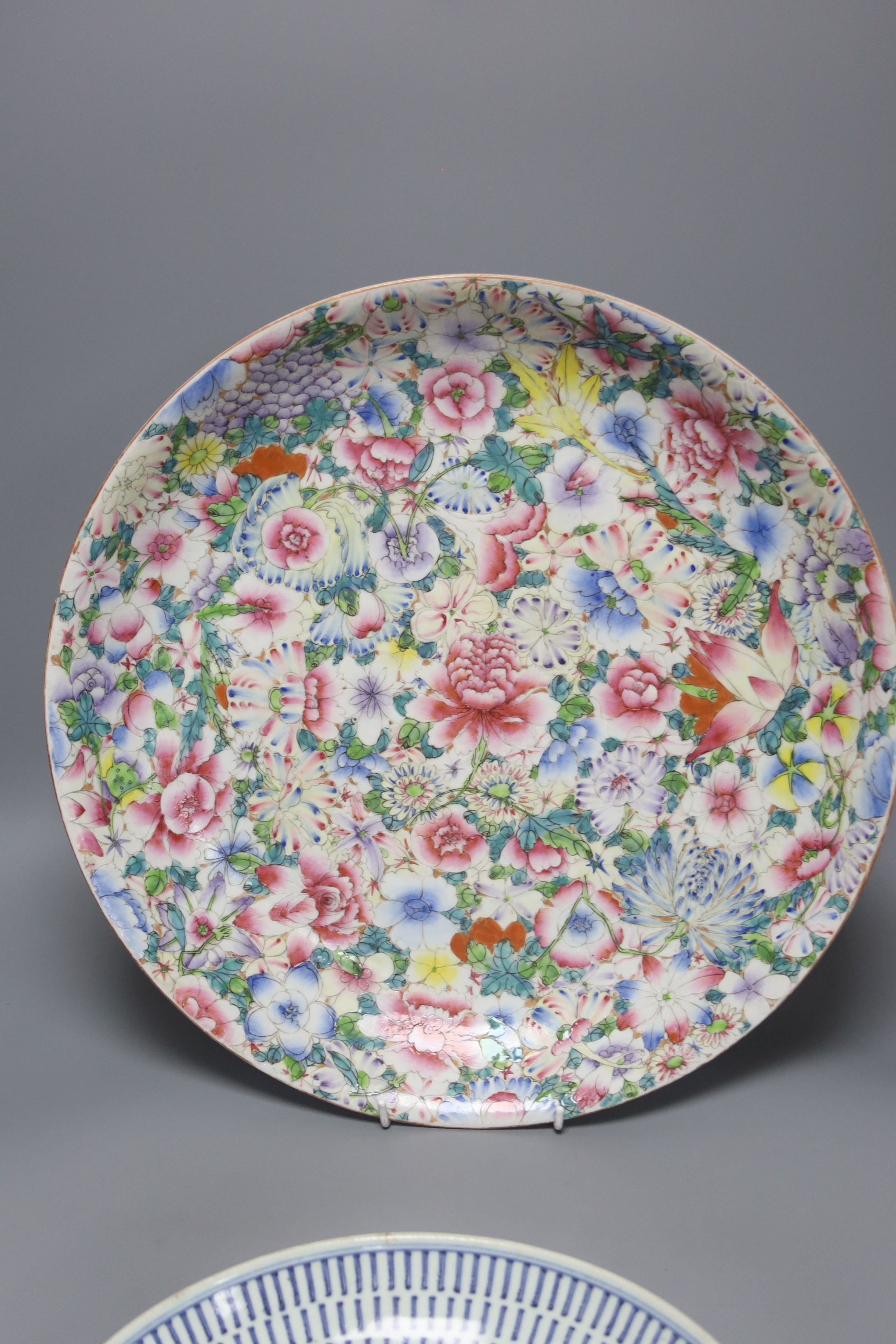 A Chinese thousand flower enamelled porcelain dish, 20th century, 40.5cm, and a mid 19th century Chinese blue and white dish, 26.5cm